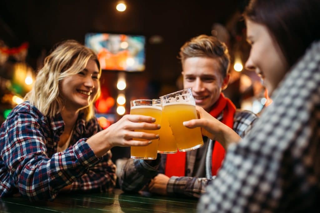 Football fans drinks beer in sports bar